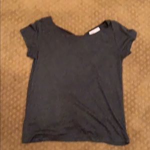 Dark gray shirt with cut out back.